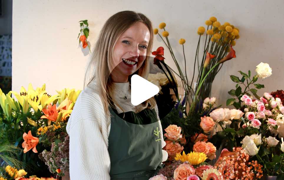 Katharina showcasing her floral creations in a bright space